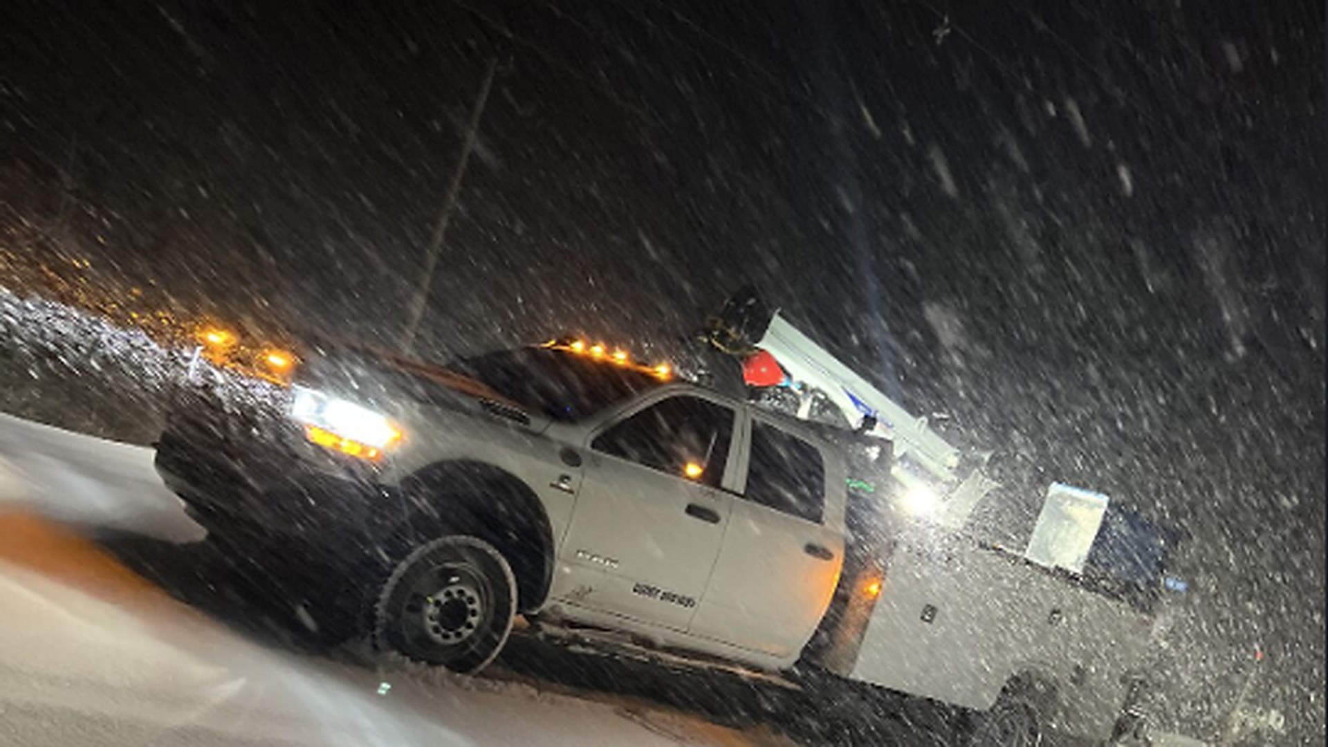 VOLTS service truck working in a night snowstorm
