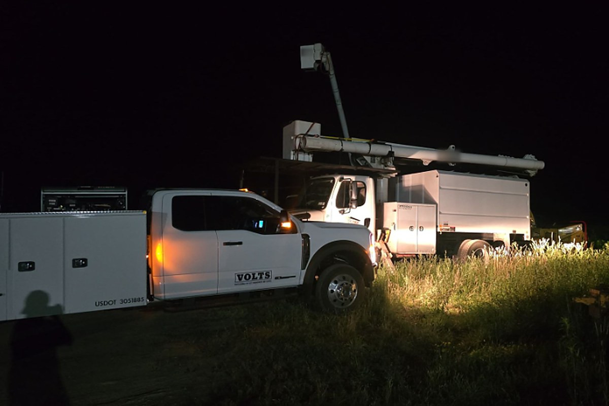 VOLTS pickup and bucket truck on a night service call