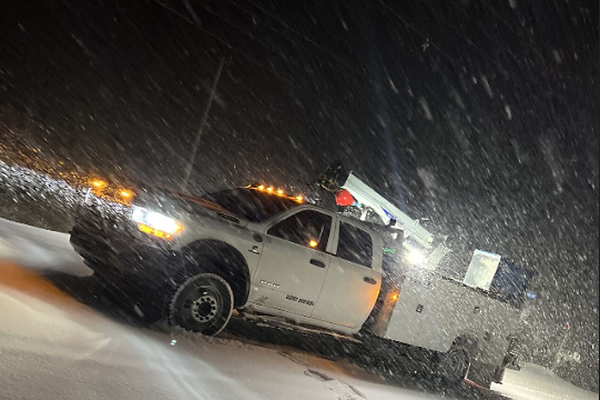 VOLTS service truck working in a night snowstorm