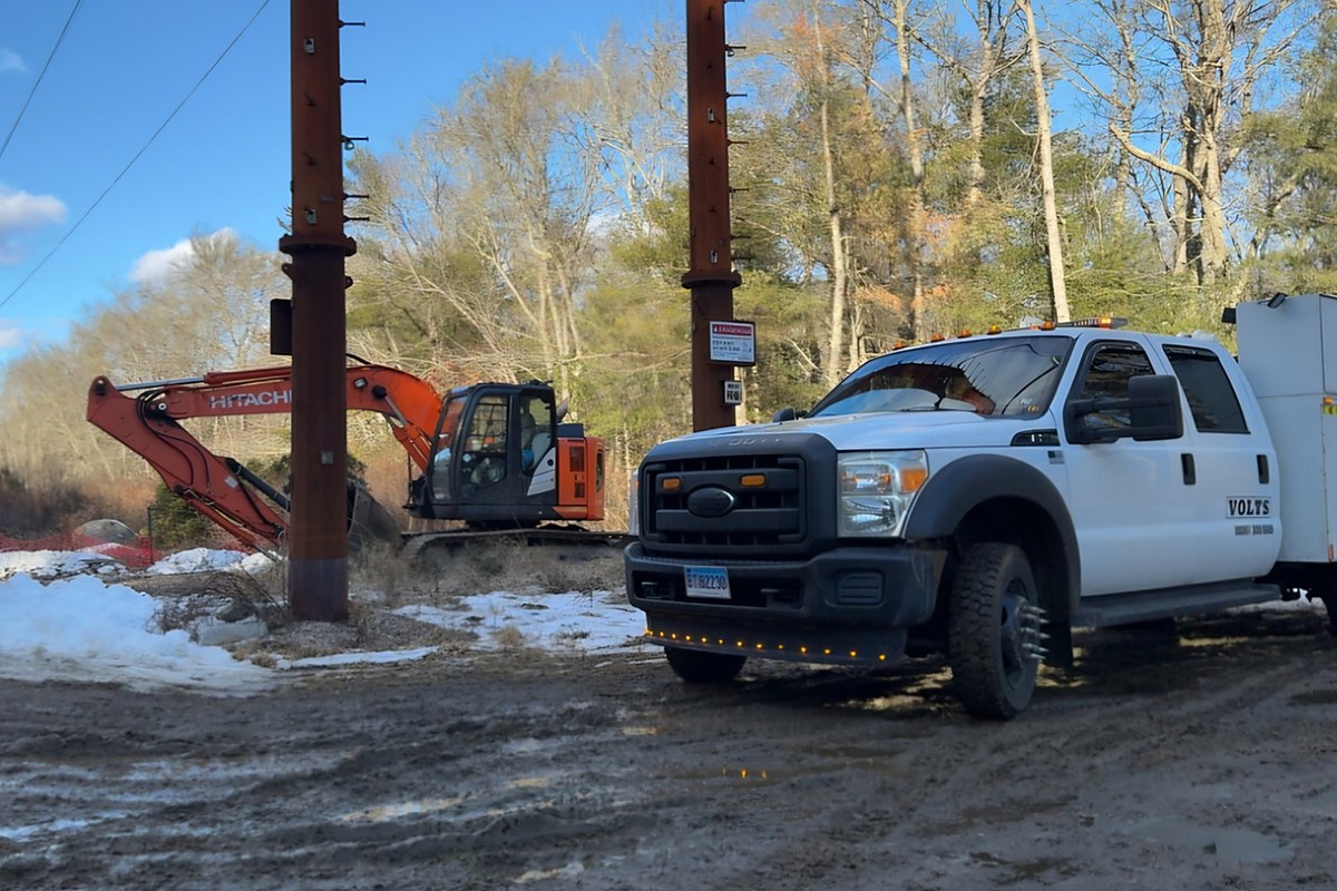 VOLTS service truck on a utility jobsite with an excavator