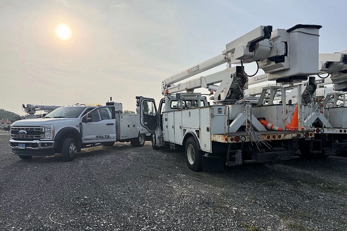 VOLTS service truck beside bucket trucks on a yard